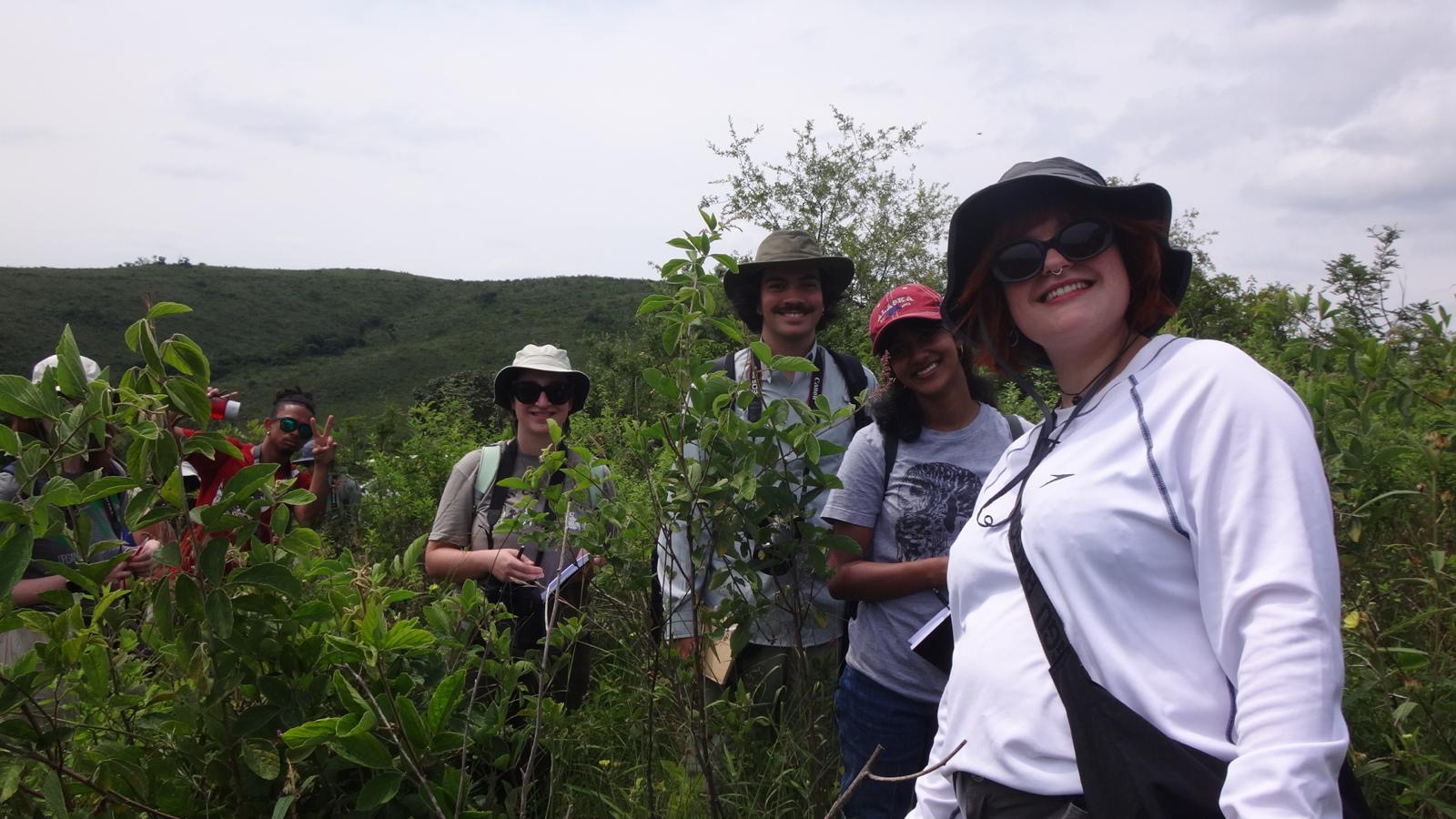 Cecilia Wagner and study abroad friends smile for a photo in South African grasslands.