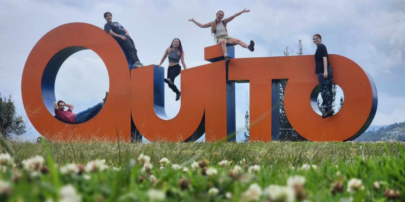 Students posing with Quito sign