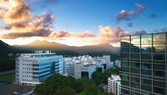 Skyline view of HKUST campus with glass building in the foreground