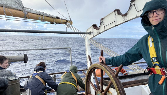 Ana Hoffman Sole steers a ship. 