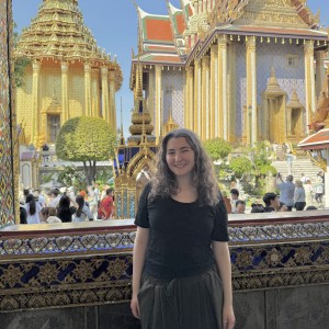 Ella Rimland smiles for a photo in front of a temple in Thailand.