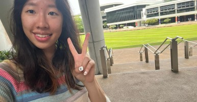 Global Intern smiles and holds up peace sign on the campus of National University of Singapore.