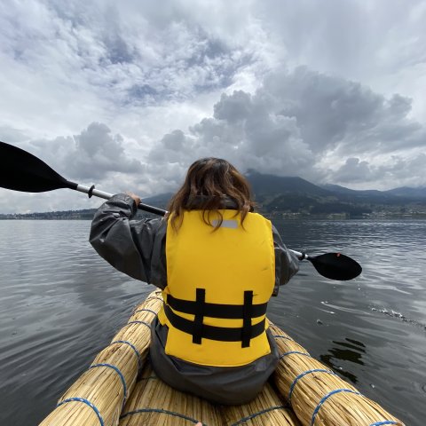 Student paddling in straw kayak