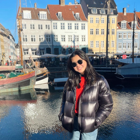 Student Ally Mark smiles for a photo by Copenhagen's iconic Nyhavn.