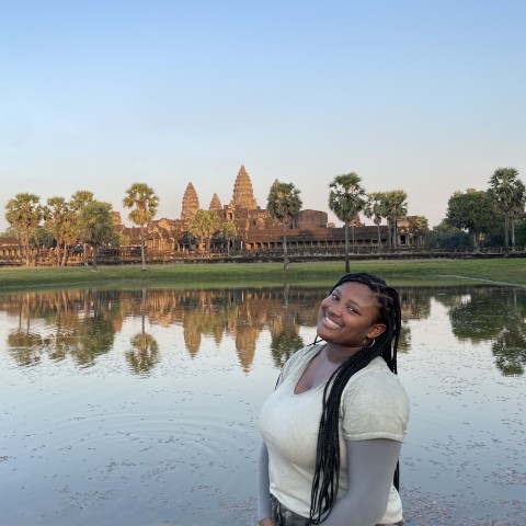 Aja'nae Hall-Callaway smiles for a photo in front of the Angkor Wat-Hindu Buddhist temple complex.