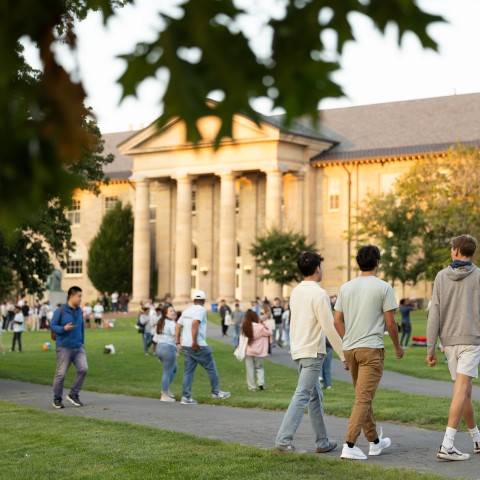 Students walk around a busy Arts Quad.
